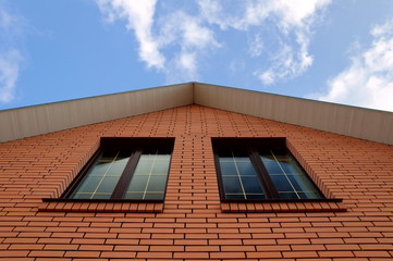 A house wall with two large windows