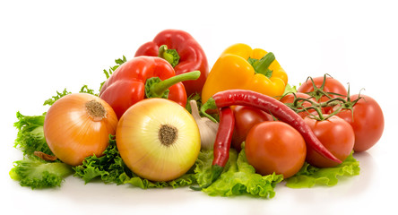 colorful vegetables lie on salad leaves