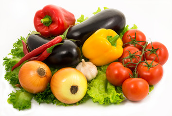 colorful vegetables lie on salad leaves