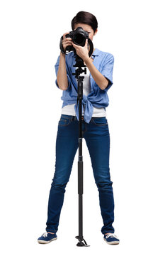 Woman takes snapshots holding photographic camera with monopod 