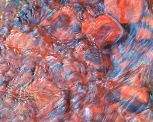 pink color ferrous water of a river