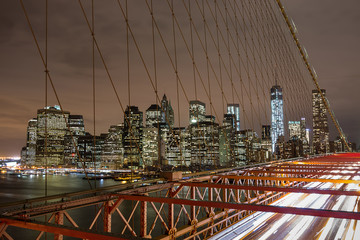 Naklejka premium New York city night skyline from Brooklyn bridge