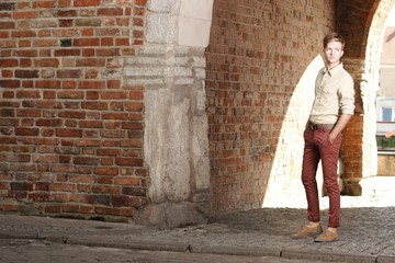 Fototapeta na wymiar Young handsome man on street, old town Gdansk