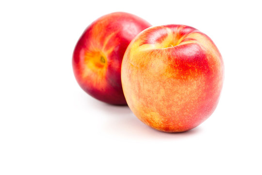 Close up of two peaches, isolated on white