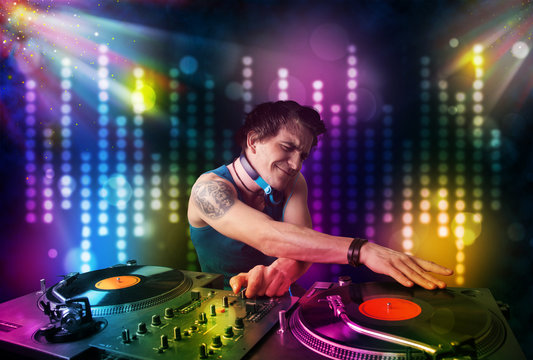 Dj playing songs in a disco with light show
