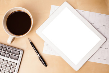 Tablet pc with empty space and a cup of coffee on a desk