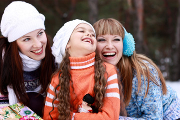 Happy three girls in the winter forest