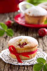 Strawberry muffins on a wooden board.