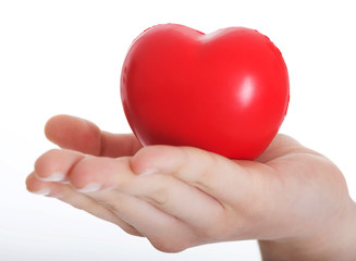 Red heart held on a female's hand.