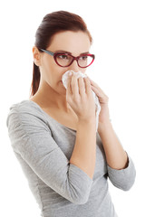 Casual beautiful woman in eyeglasses with tissue.