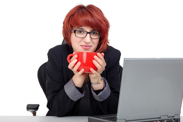 Woman sitting on laptop and drinking from the cup