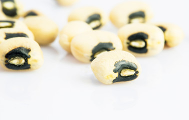 Black eyed peas spilled on a wicker mat