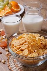 Cornflakes with milk and dried fruit. vertical