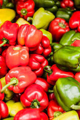 Red, green and yellow sweet bell peppers natural background.