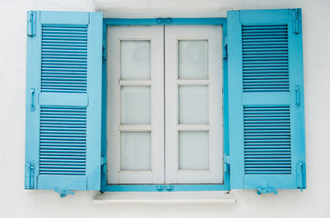 Blue wooden window on white wall