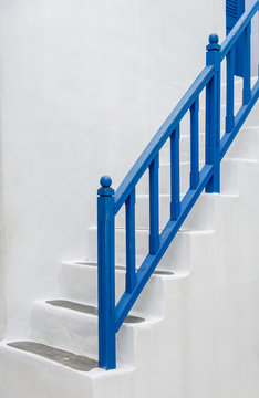 Blue handrail with white stairs