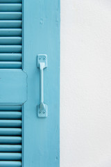 Blue wooden window on white wall