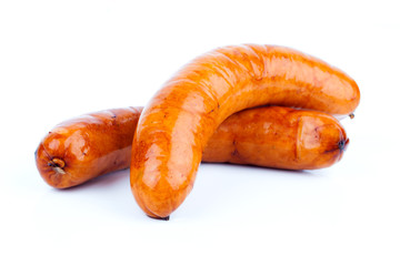 Stack of cooked sausages, on a white background