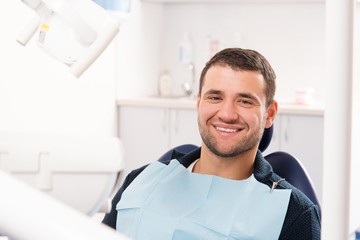 Fototapeta premium Smiling young man at dentist's surgery