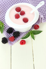 Delicious yogurt with berries on table close-up