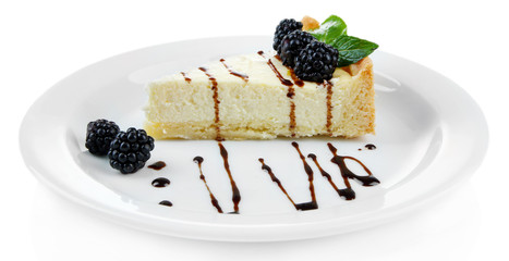 Slice of cheesecake with chocolate sauce and blackberry