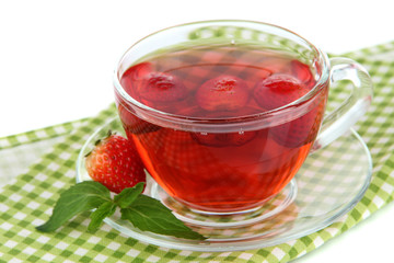 Delicious strawberry tea on table on white background