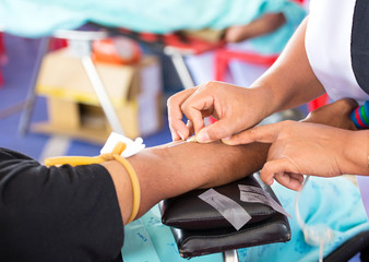 arm of a donor donating blood at hemotransfusion station