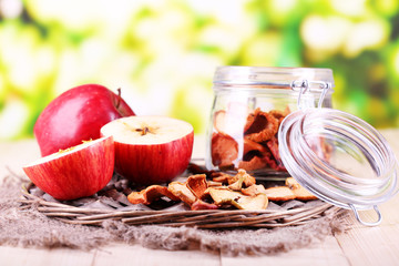 Dried apples in glass jar, on   bright background
