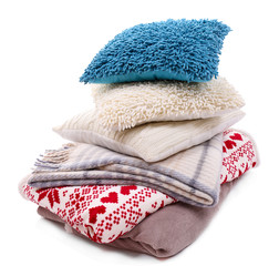 Colorful pillows and plaids isolated on white