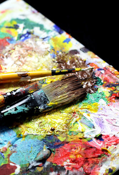 Beautiful vivid art palette and mix of paintbrushes