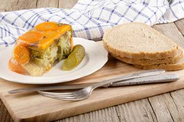 vegetable aspic and bread on a wooden board