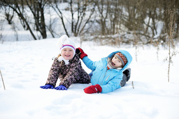 Fototapeta na wymiar Children having fun in winter time