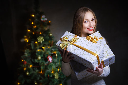 christmas. smiling woman with many gift boxes