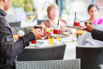 Waiter carrying a plate with salad dish on a wedding.