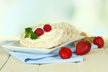 Tasty crispbread with berries, on white table