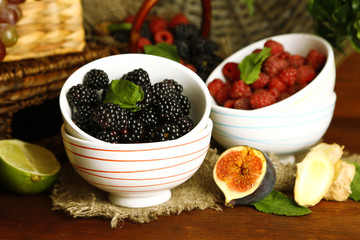 Assortment of juicy fruits and berries on wooden background