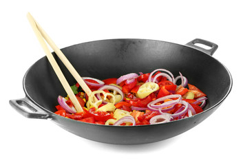 Vegetables in wok isolated on white