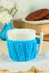 Cup with knitted thing on it close up