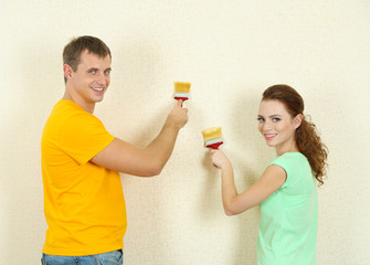 Young couple doing renovation in new house