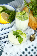 Cucumber yogurt in glass bowl and homemade bread,