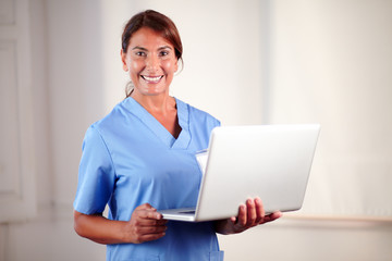 Professional female doctor holding a laptop