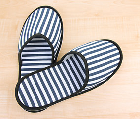 Striped slippers on wooden background