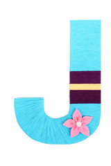 Letter J created with brightly colored knitting yard isolated