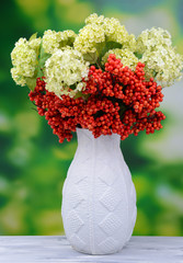 Flowers and berries in vase,