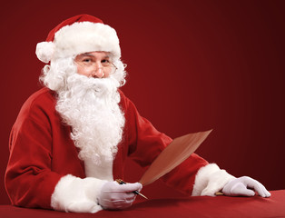 Portrait of Santa Claus looking at envelope in his hands
