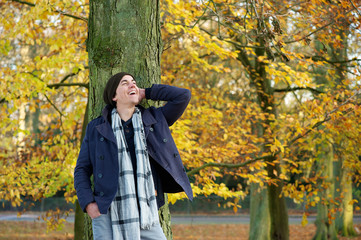 Young man smiling outdoors in the countryside on a autumn day