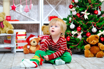 Excited little boy looking for his present in Christmas stocking