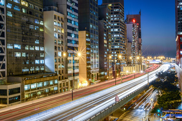 Fototapeta na wymiar Traffic through city at night in Hong Kong