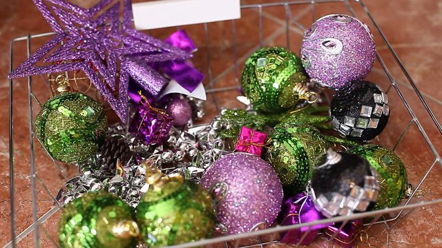 Taking some christmas balls from a hamper