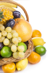 Fresh fruit in a wicker basket on the white